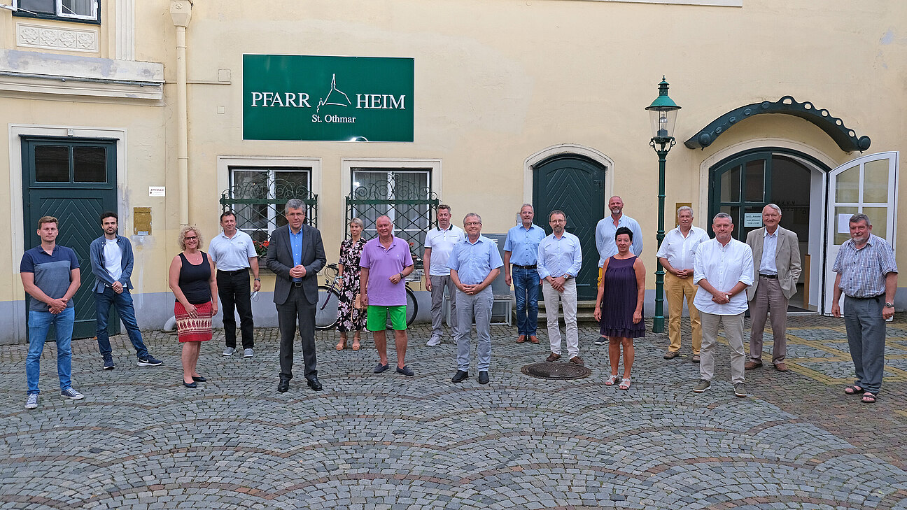 Eine Gruppe von Personen steht vor dem Mödlinger Pfarrheim.
